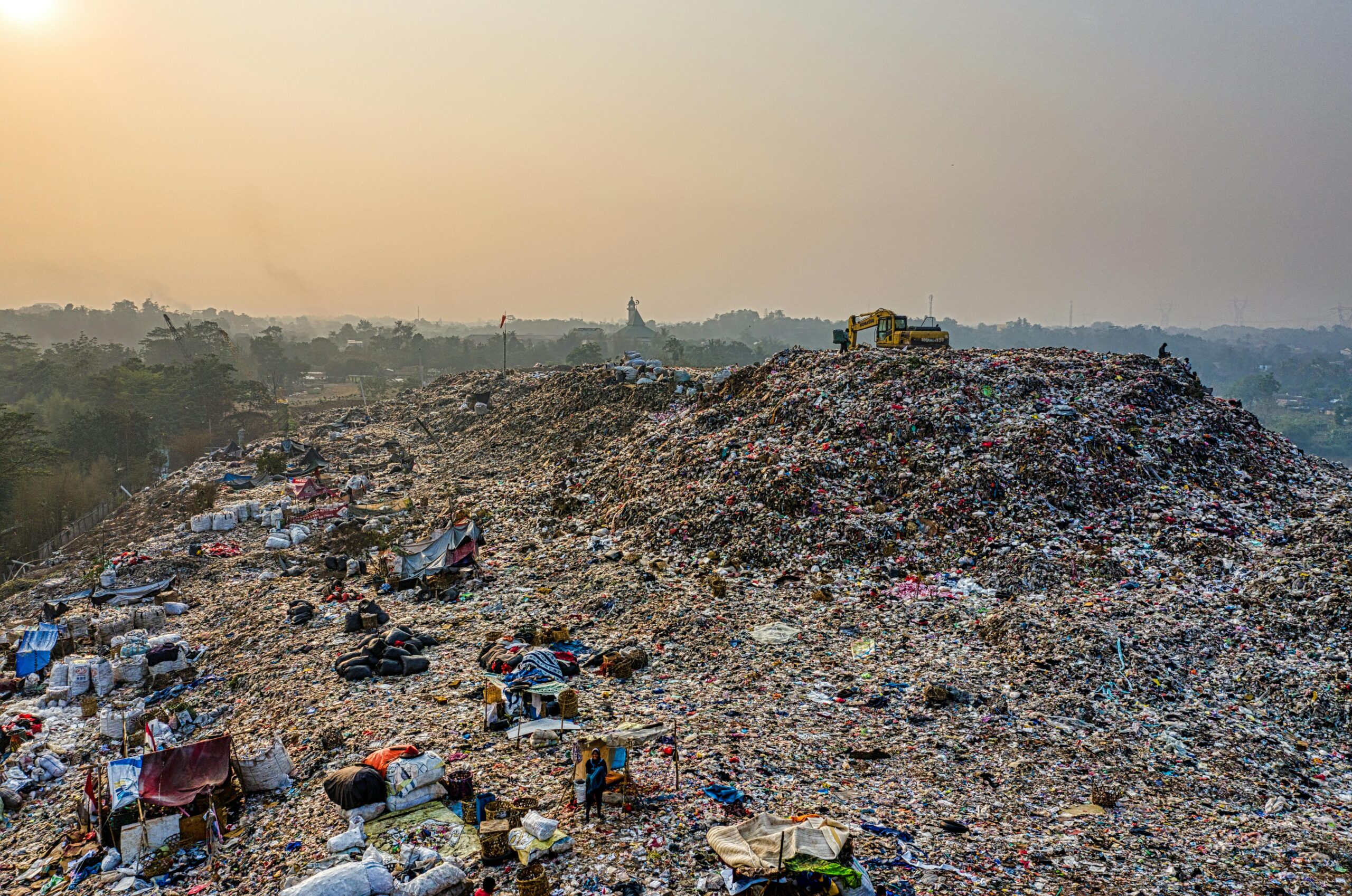 Aerial shot of a large landfill with garbage piles, showcasing waste management challenges.
